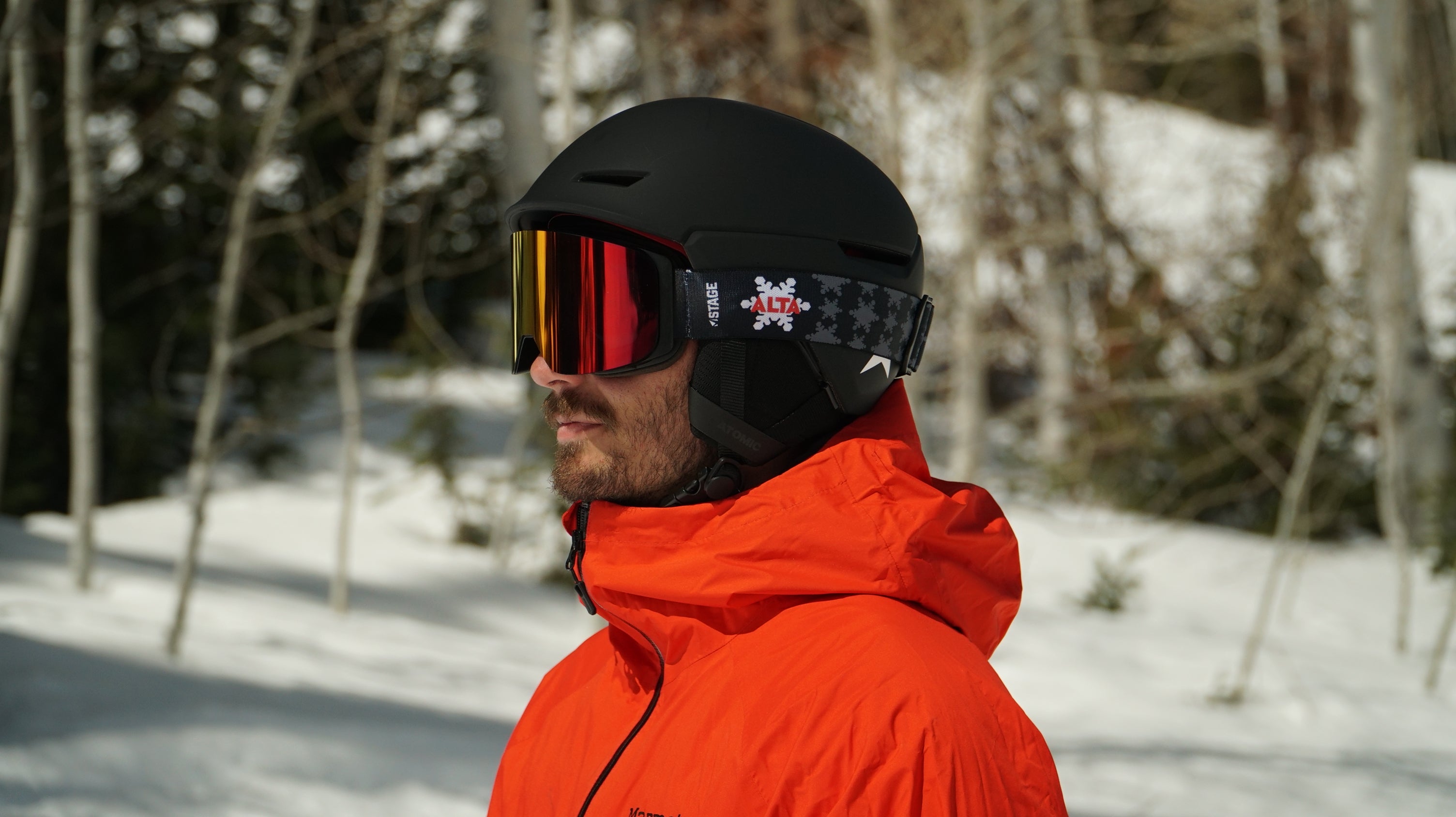 A man wearing STAGE Custom Ski Goggles featuring the ALTA Ski Resort logo on the STAGE Propnetic Magnetic Ski Goggle.