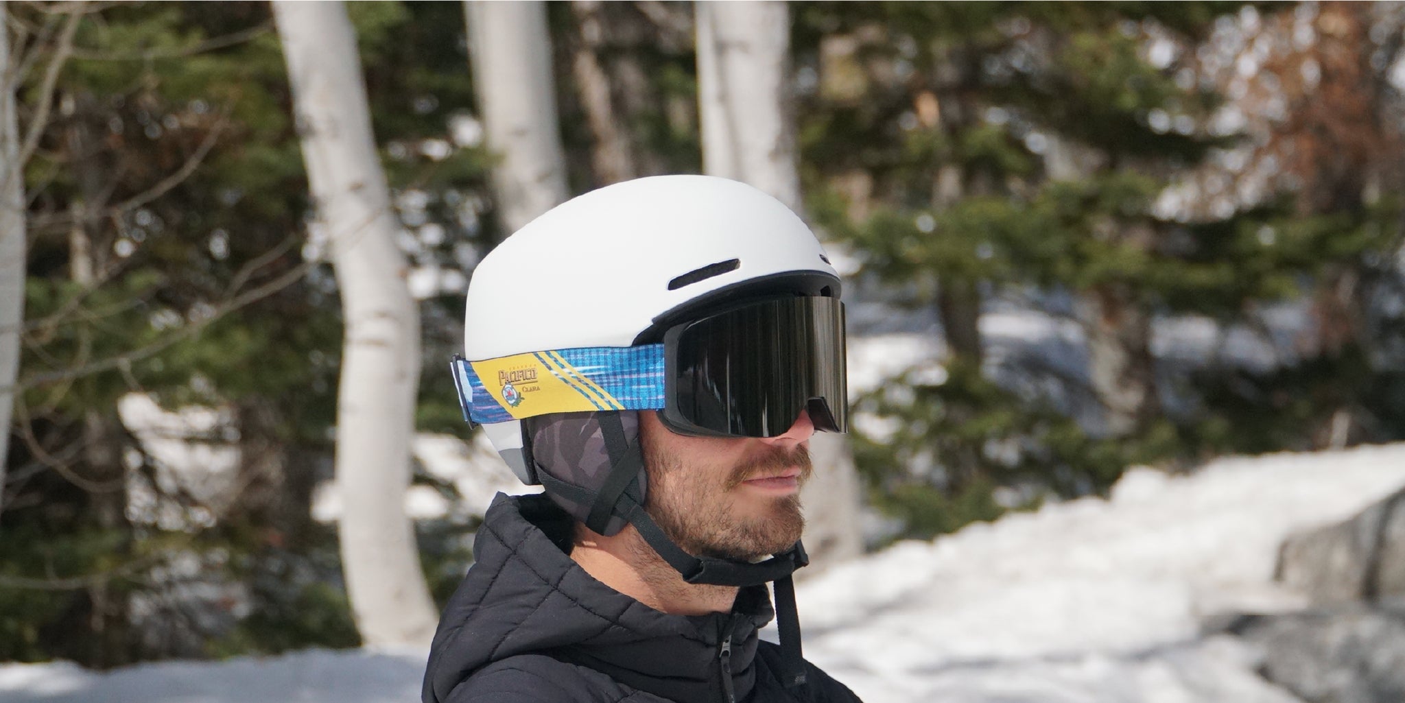 A man wearing STAGE custom goggles showcasing Pacifco's custom ski goggles.