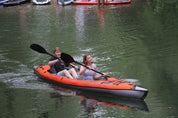 Two children kayaking with the STAGE 2-Piece Kayak Paddle and an Advanced Elements Inflatable Kayak