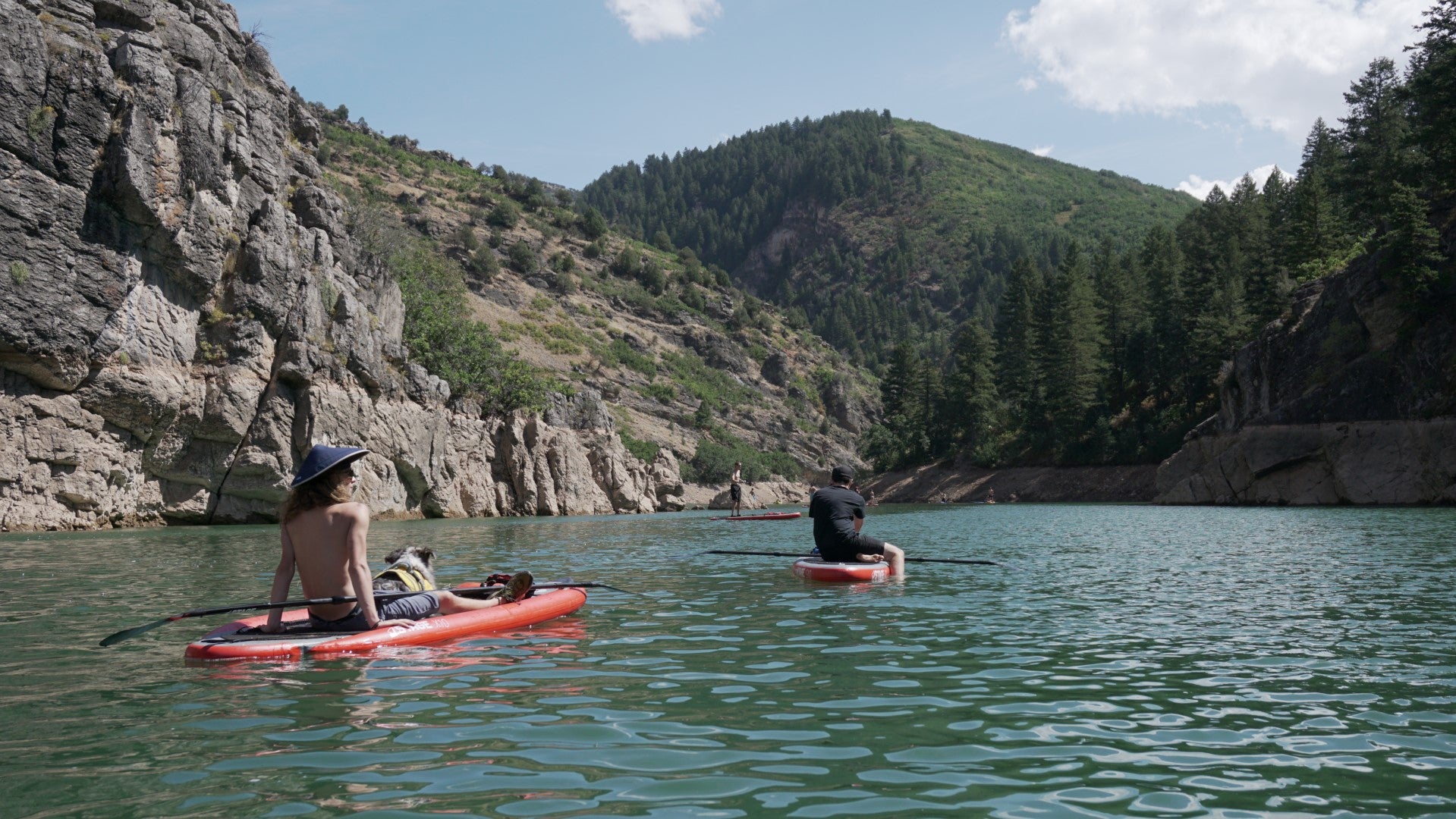 Two paddleboarders chilling on their paddleboards and holding STAGE 2SIDE Double-Sided paddleboard paddles on Causey Reservoir in Utah.