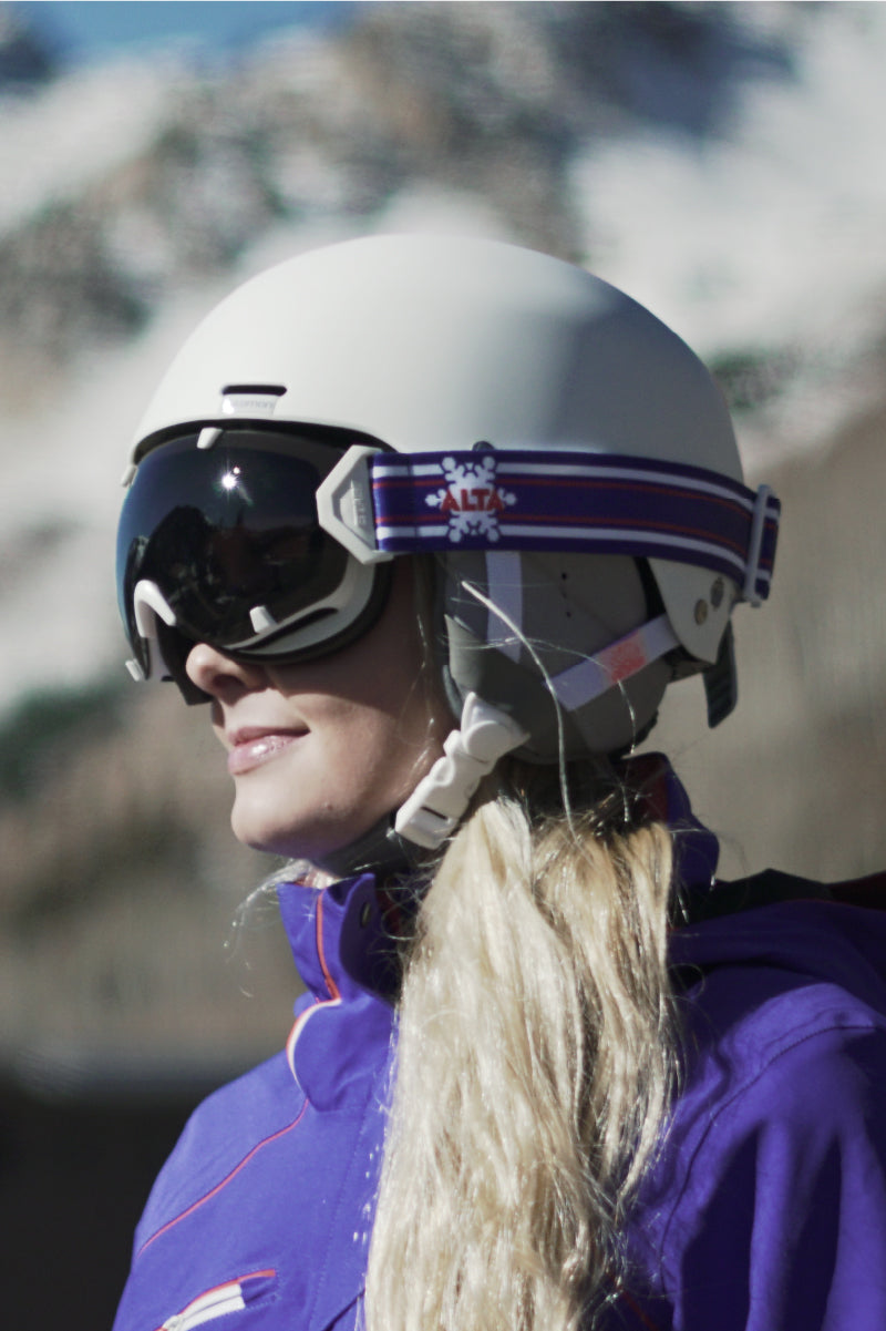 A woman wearing STAGE Custom Ski Goggles featuring ALTA Ski Resort's logo.