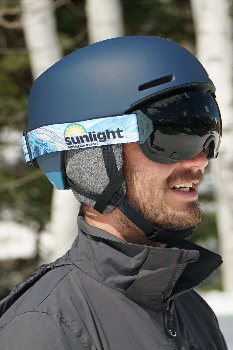 A man wearing STAGE Sunlight Mountain Resort custom goggles perfect for Champagne Celebrations, Skiing, Snowboarding, and generating brand awareness.